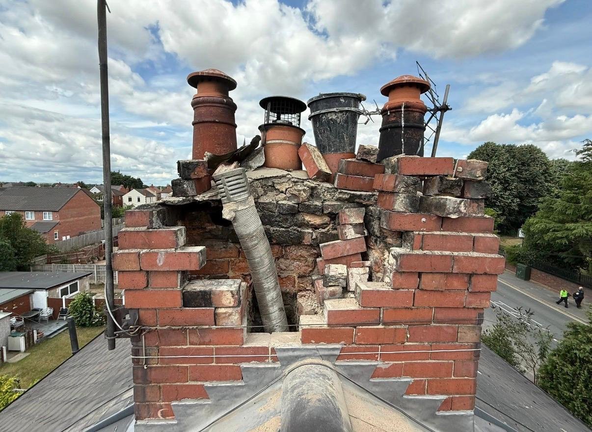 Chimney before the work, showing damaged upper brickwork