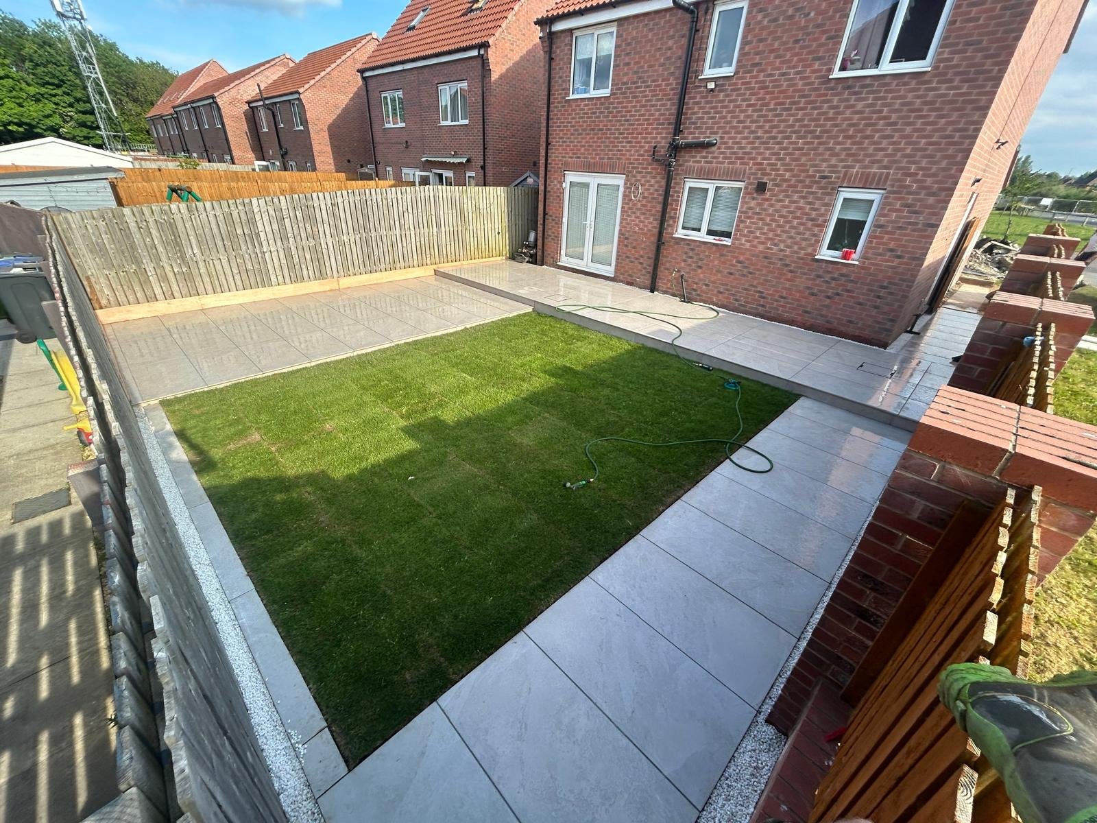 A lawn with a paved border from an L&R garden project